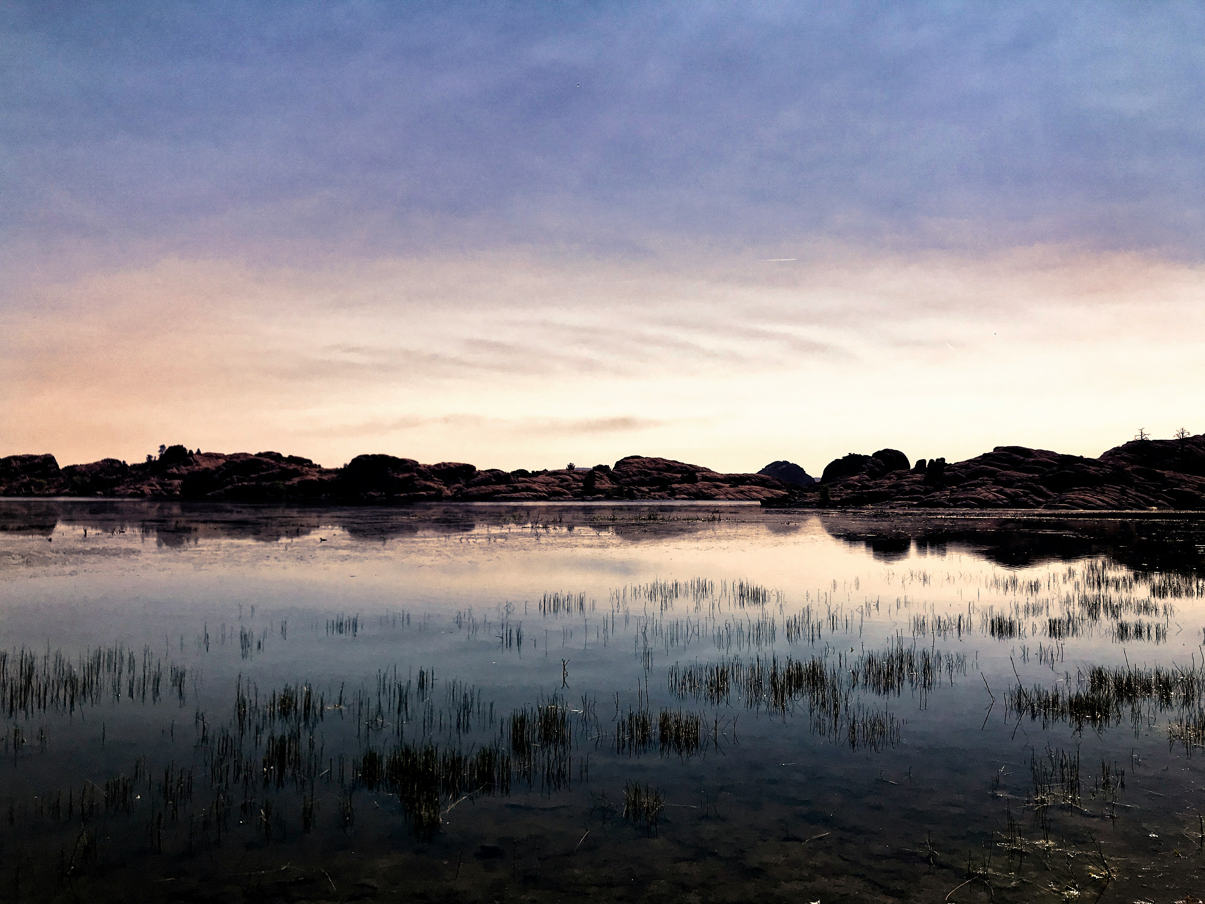 photography of body of water and mountain during daytime